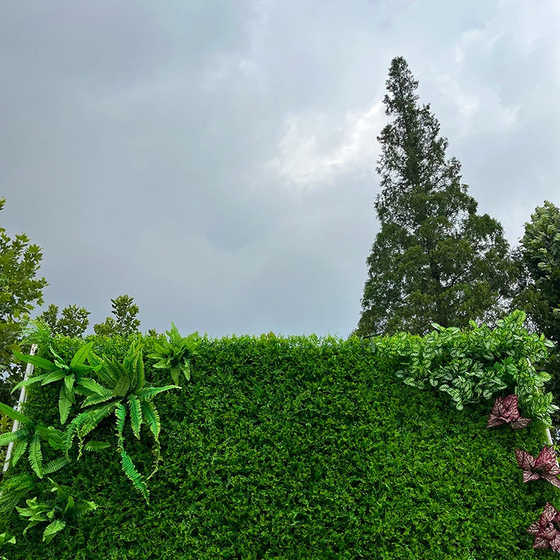 Artificial greenery backdrop for event photo booth.