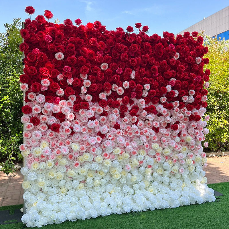 Floral wall with red, pink, and white fabric flowers in a gradient pattern.