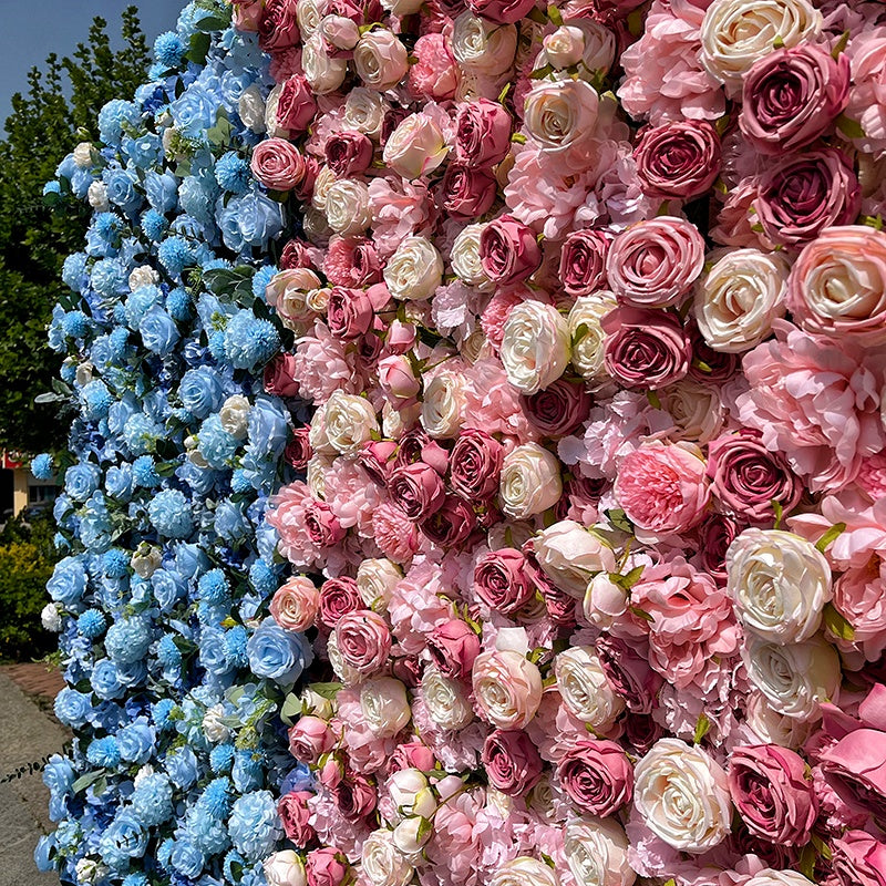 Wall of artificial flowers in blue, pink, and white arranged in a pattern.