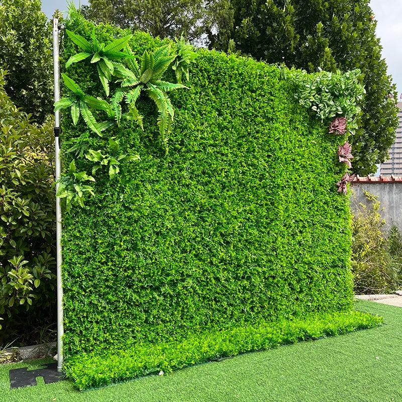 Artificial green wall with plants in a garden setting